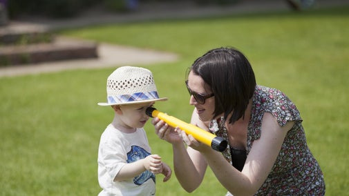 A child looking through a telescope at Sissinghurst